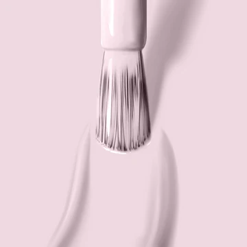 Close-up of LONDONTOWN’s Afternoon Tea nail polish brush applying light pink polish on a matching pink surface.