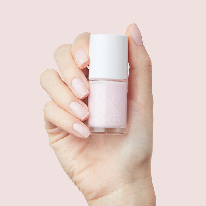 Bare Nail Set showing soft pink nail polish on natural nails held against a light pink background