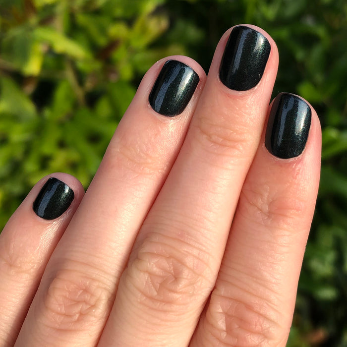 Fingernails painted with LL gel polish in glossy black for a sleek, long-lasting manicure by Olive and June