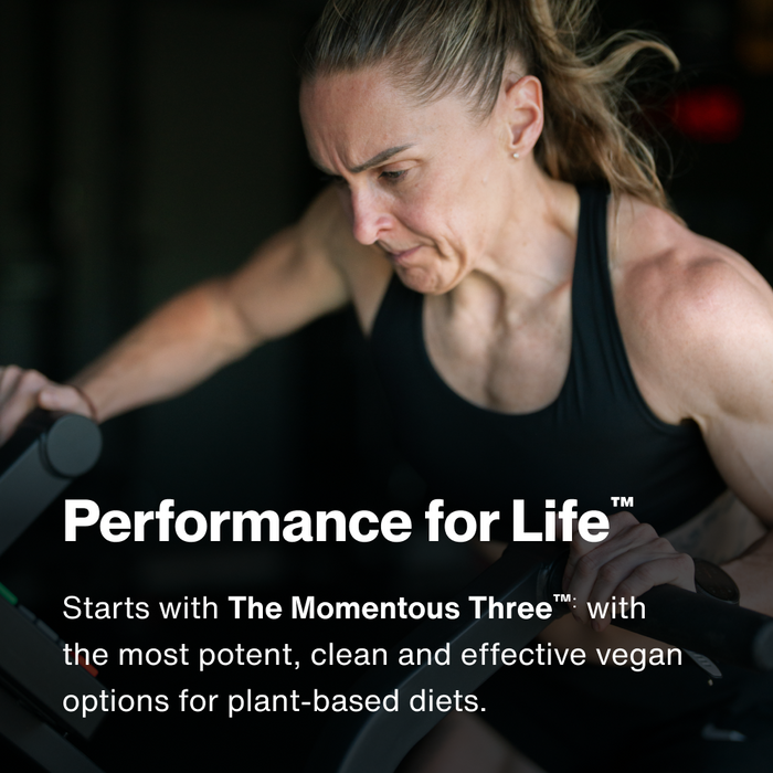Woman in black sleeveless top performing weightlifting exercise with dumbbell.
