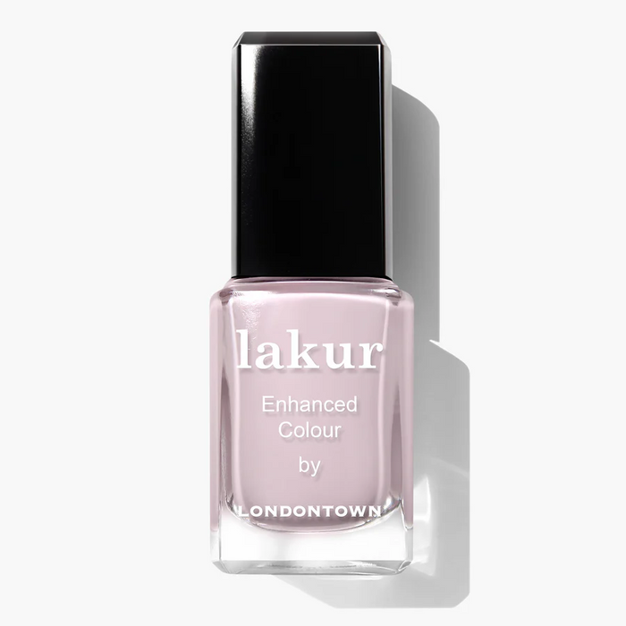 A bottle of LONDONTOWN Lakur nail polish in the shade Afternoon Tea, a light mauve color with a black cap.