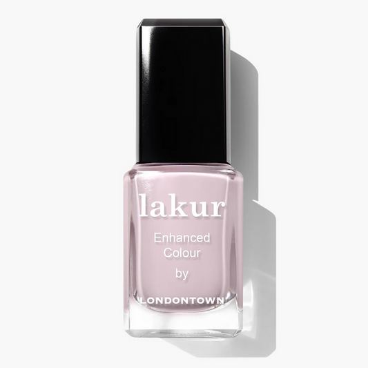 A bottle of LONDONTOWN Lakur nail polish in the shade Afternoon Tea, a light mauve color with a black cap.
