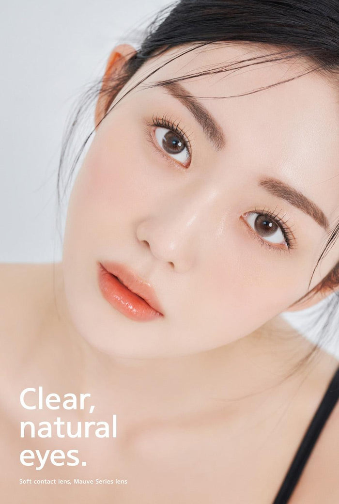 A close-up of a model demonstrating a natural makeup look with Ann365 Mauve Milk Brown circle colour contacts, highlighting how well the contact lenses blend with her dark eyes.