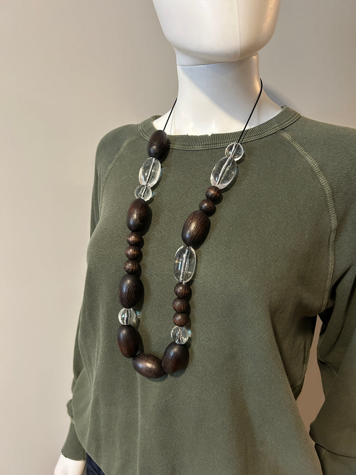 A.P.C. bead necklace featuring colorful round beads and a silver clasp, displayed on a neutral background.