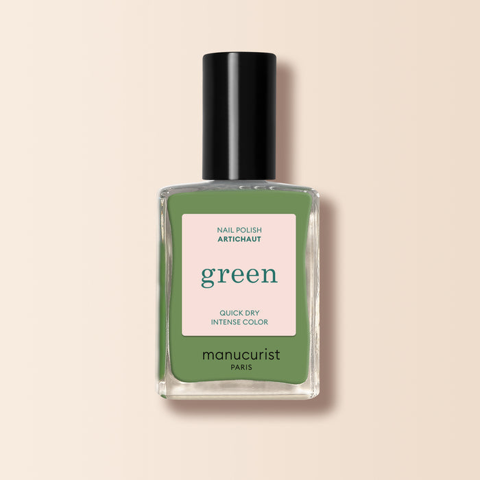 A bottle of Manucurist Artichoke nail polish from the Green™ range, featuring a black cap and a square label with the product name and description on a light beige background.