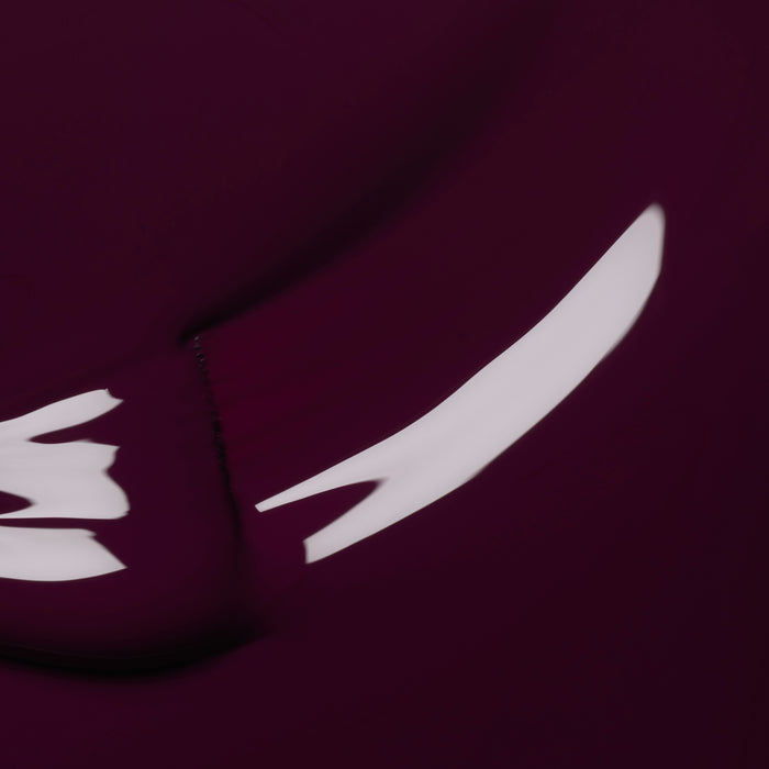 Aubergine by Manucurist features an abstract design with a deep purple background and white, curved streaks like brush strokes, creating a sense of motion and fluidity across its dark, smooth surface.
