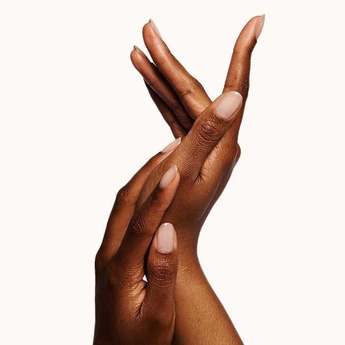 Glossy neutral manicure on hands with moisturized skin using the Bare Nail Set for a polished at-home mani