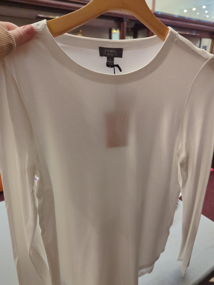 Camille & Co. basic long sleeve top in a neutral color, showcasing a comfortable fit and simple design for casual wear.