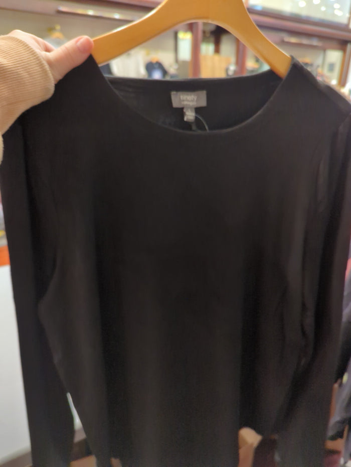 Camille & Co. basic long sleeve top, soft fabric, fitted design, in neutral color, hanging on a hanger against a plain background.