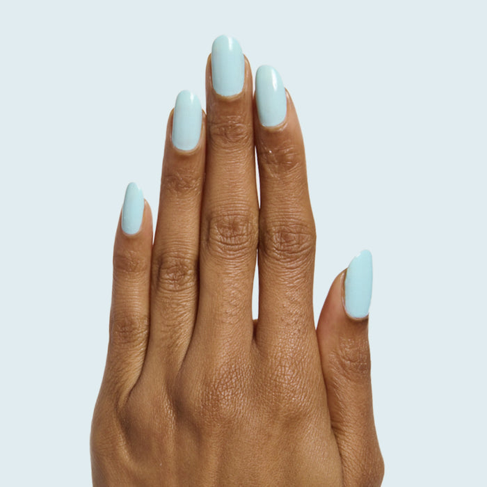 Hand with long oval nails painted pastel soft turquoise in Berry Basket gel polish by Olive and June