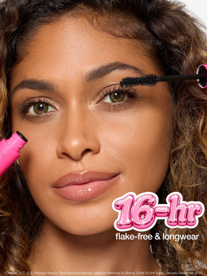 A mascara brush with twisted double fiber bristles, described as an hourglass shape that hugs the lashline for maximum pigment. Text highlights: confidence booster brush, hourglass shape hugs lashline, max pigment.