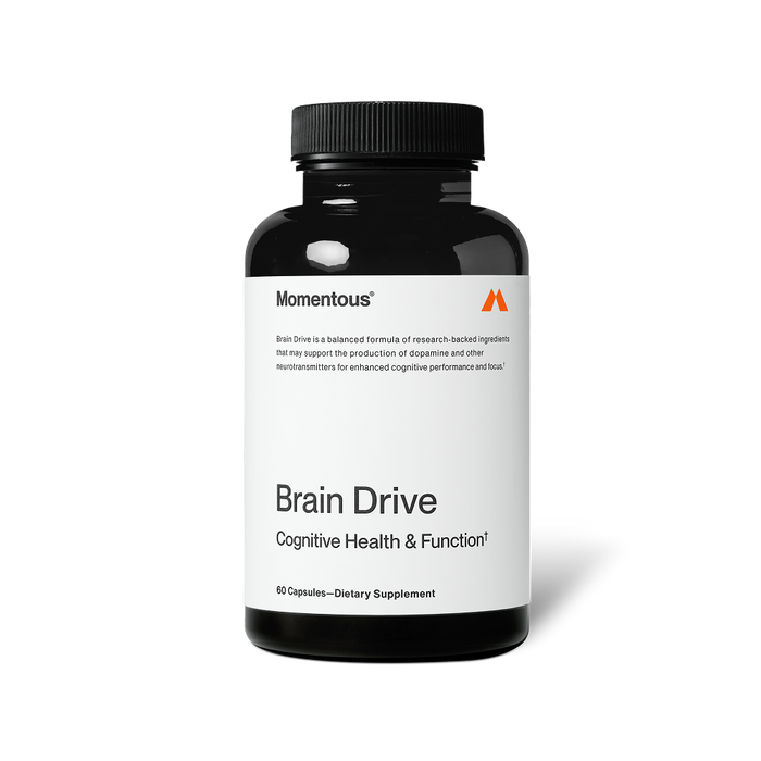A black bottle of Momentous Brain Drive dietary supplement is shown centered on a black background with a white label. Text on the label reads: “Momentous®” “Brain Drive is a balanced formula of research-backed ingredients that may support the production of dopamine and other neurotransmitters for enhanced cognitive performance and focus.†” “Brain Drive” “Cognitive Health & Function†” “60 Capsules—Dietary Supplement”