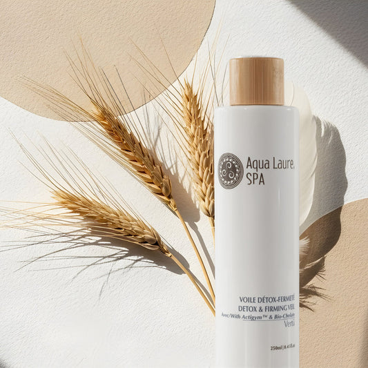 Aqua Laure SPA Detox & Firming Veil bottle with wooden cap, styled with wheat stalks on textured beige and white background