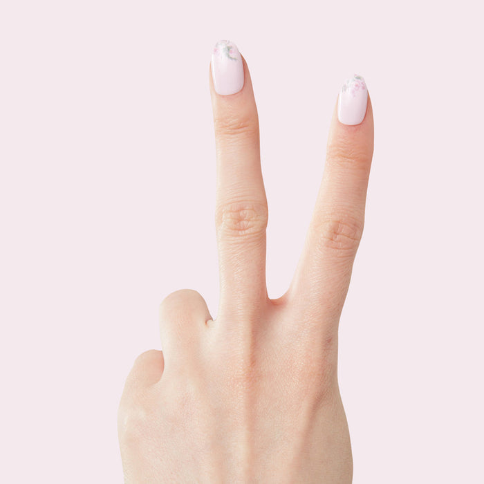 Two fingers showing Faded Florals - Press-On | Short | Round with pale pink and subtle floral tips manicure