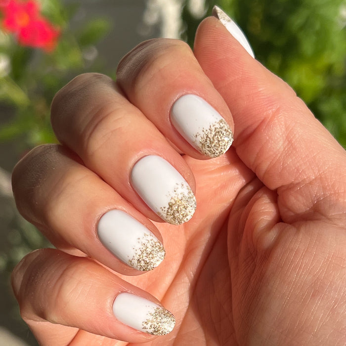 Glitter Gradient | Round | Short press-on manicure with white base and sparkling gold glitter tips for quick at-home mani