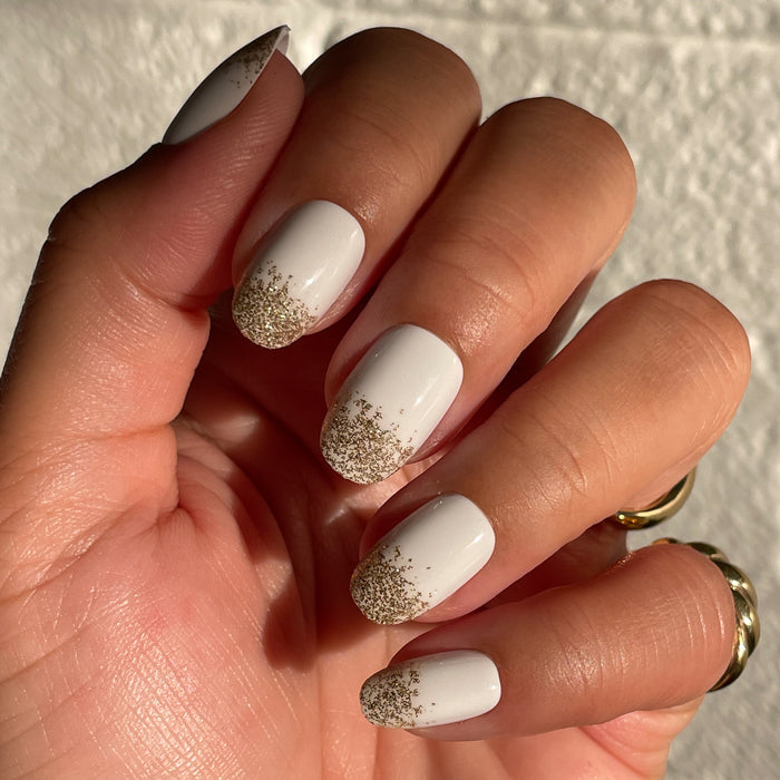 Glitter Gradient | Round | Short press-on manicure with white base and delicate gold glitter gradient for easy at-home mani
