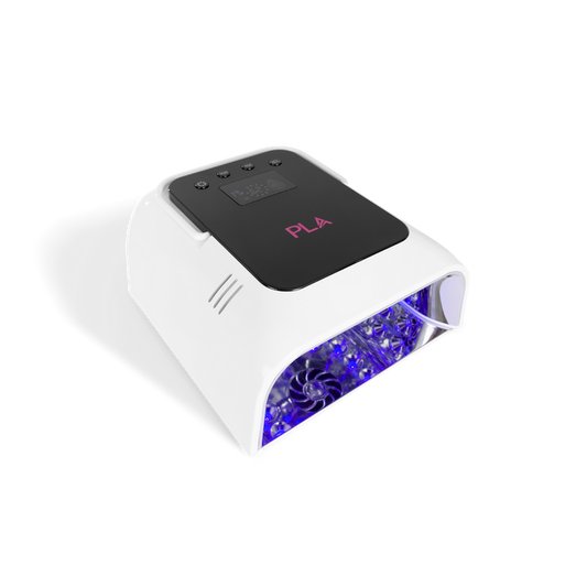 A white UV LED nail lamp with a black control panel featuring pink PLA branding, emitting blue light from the open front compartment, shown on a white background.