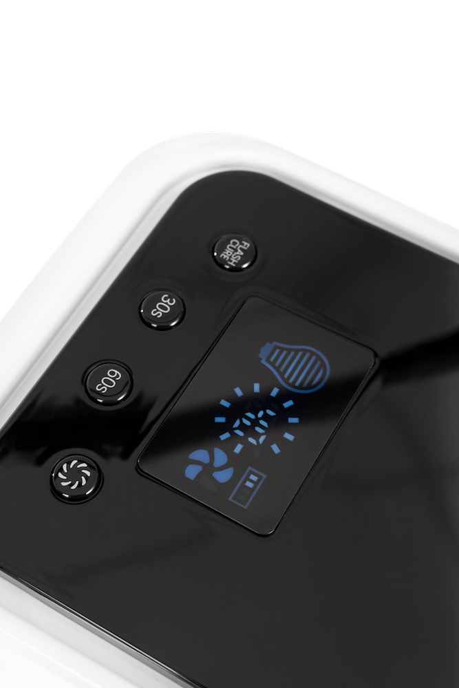 Close-up of a black and white Nail Light device with a glossy finish, featuring four circular buttons labeled 60s, 90s, Flash Cure, and a central screen displaying blue icons, set against a white background.