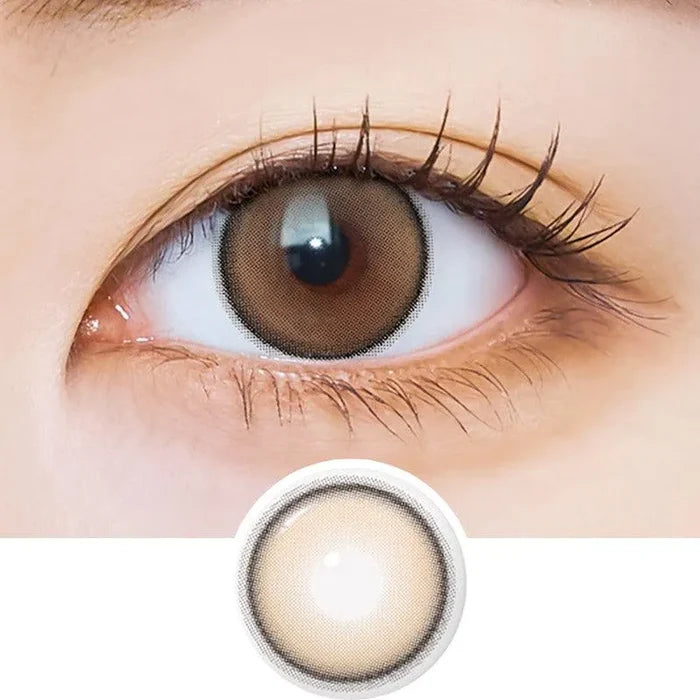Macro shot of an eye wearing the i-Sha Dekame Hug Me Brown prescription colour contact lens, showing the multi-colored detail and natural effect on dark brown eyes, with clean eye makeup. At the bottom is the pattern of the colored lens design, showing the dotted detail and pigmentation.