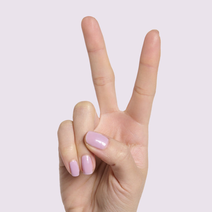 Hand showing medium-length nails with glossy Lavender Stems milky sheer gel polish manicure by Olive and June