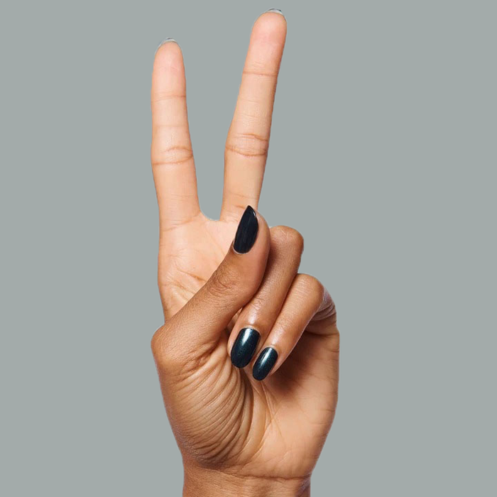 Hand with nails painted in deep shimmering emerald green using LL for a sleek, long-lasting manicure look
