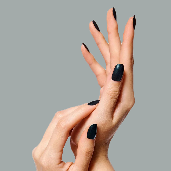 Hands with nails painted in glossy black using LL for a smooth, long-lasting manicure look by Olive and June