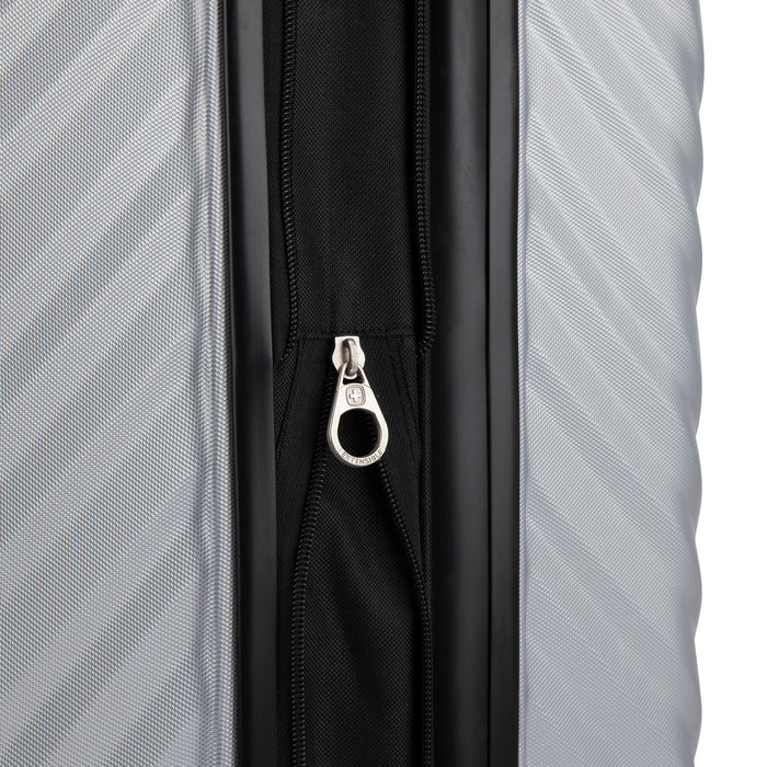 Close up view of a luggage called MOD designed by Swiss Gear sold at Bentley, showcasing its zipper pull tab with the logo