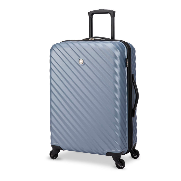 Front side view of a silverish blue hard side luggage called MOD designed by Swiss Gear sold at Bentley, showcasing its telescopic handle and resistant-absorbant texture.