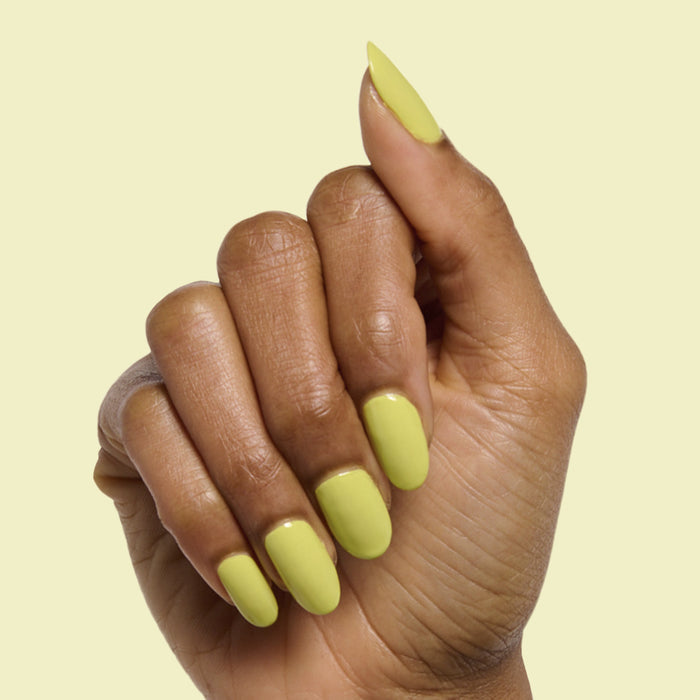 Hand with almond-shaped nails painted vibrant chartreuse green in Not Kale gel polish by Olive and June