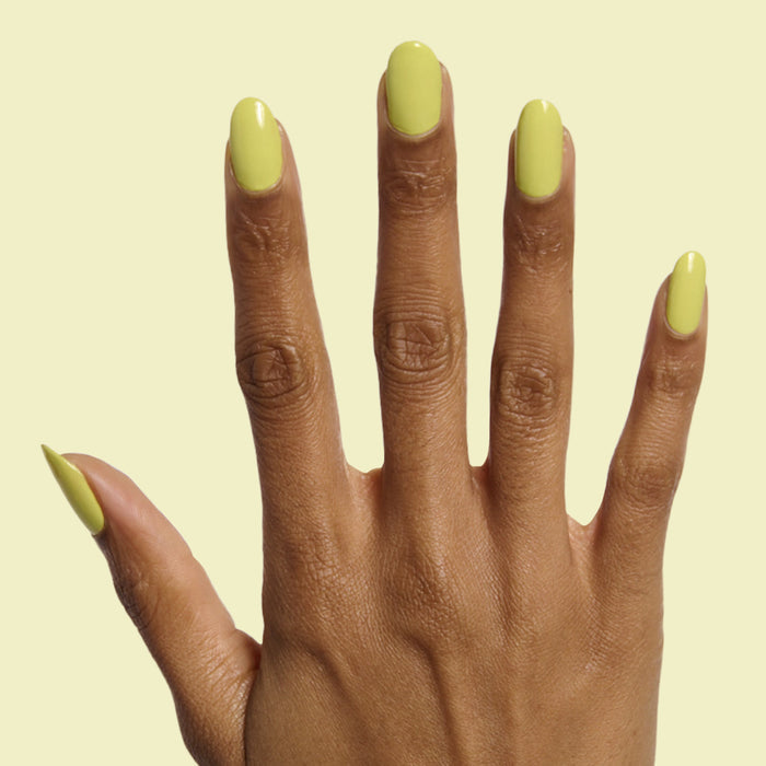 Hand with long oval nails painted zesty chartreuse green in Not Kale gel polish by Olive and June