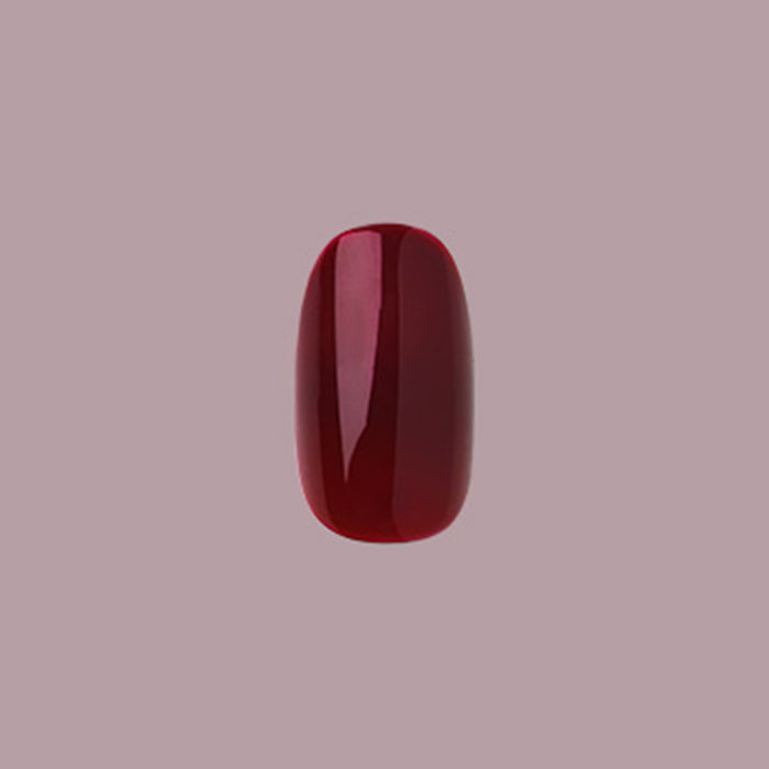 Obsessed - Press-On | Extra Short | Round single deep dark ruby red false nail on muted mauve background