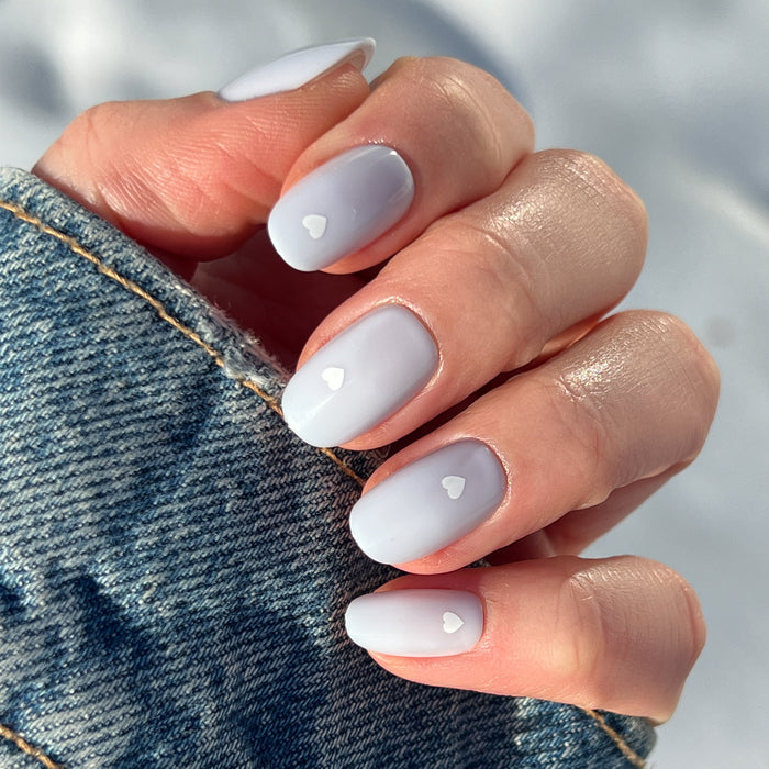 Periwinkle Vampy Heart | Round | Short nails with soft periwinkle base and small white heart accents for a charming mani