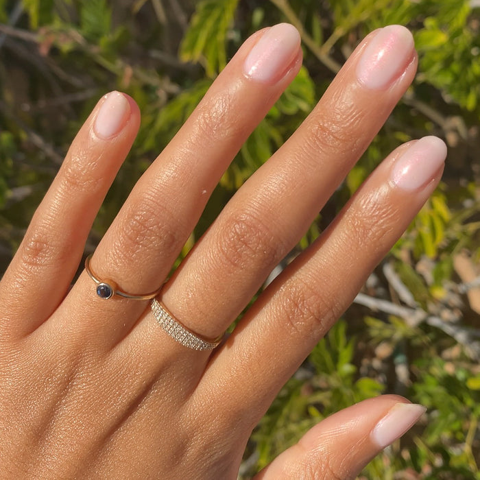Hand with natural-shaped nails painted in shimmery Pink Capiz long-lasting polish for a soft manicure look
