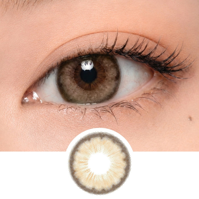 A close-up of a human eye wearing EyeCandys Pink Label Angel Brown lenses, with a separate image below showing the lens's light and dark brown pattern.