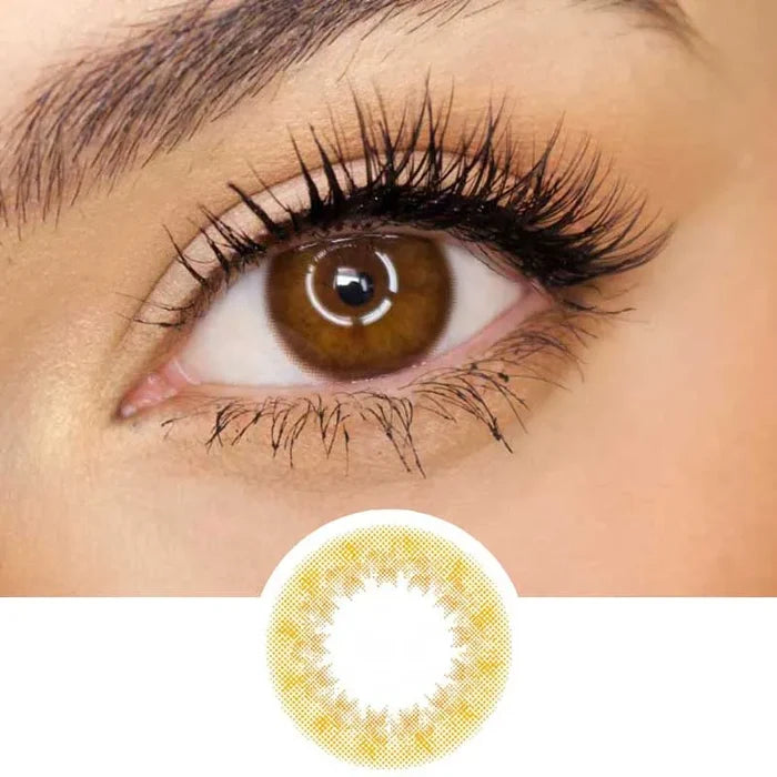 Pink Label Truffle Brown color contact lens on top of a dark eye paired with subtle eye makeup and curled wispy eyelashes, above the contact lens design.