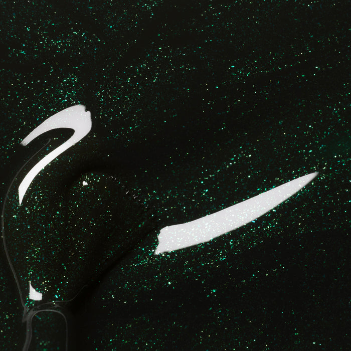 Close-up of Manucurist’s Poison, a forest green nail polish with fine glitter, featuring a glossy shimmer and visible brush strokes.