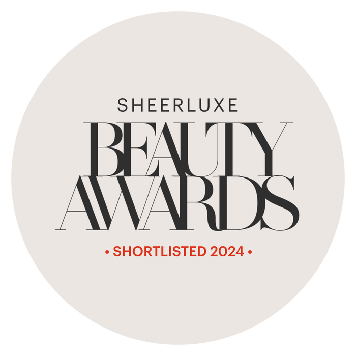A circular, light beige badge displaying the "Sheerluxe Beauty Awards" logo in black text, with "Shortlisted 2024" highlighted in red at the bottom.