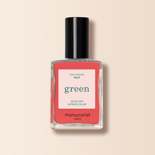 A Manucurist Pulp nail polish bottle with a black cap and a pink-white label stating Quick Dry Intense Color. Ideal for grapefruit shade fans, this Green range polish stands out against a light beige background.