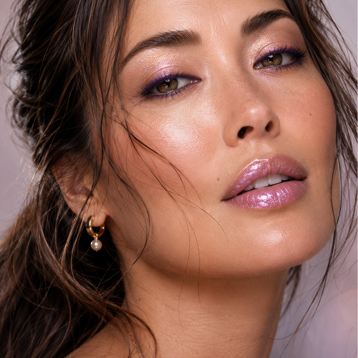 Close-up of a woman wearing a monochromatic makeup look with Runway Rogue Classic Lip Gloss in the shaded 'Purple Haze' and Eyeliner in 'Purple Rain'