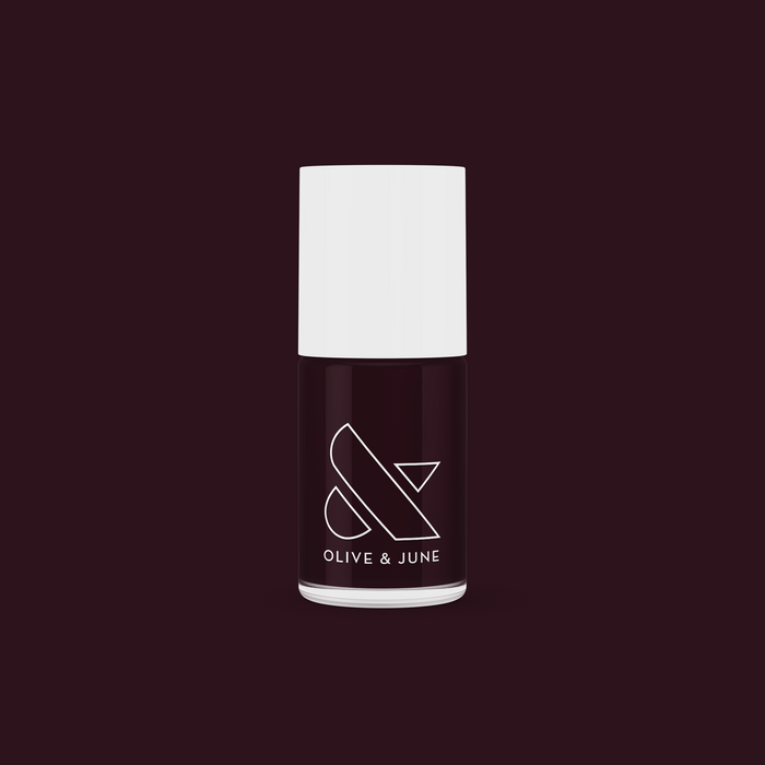 Bottle of SD nail polish in a sophisticated deep plum shade by Olive and June for long-lasting manicures