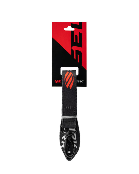 Black woven lanyard with orange stylized 'S' logo hanging from a red-and-black retail card with diagonal design.