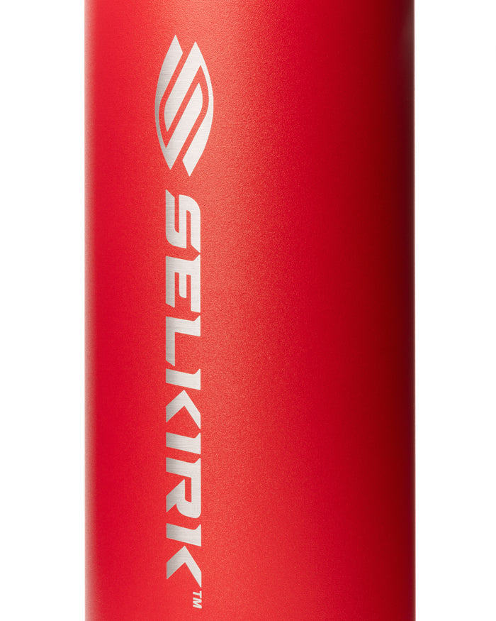 Close up of the red Selkirk Sport Premium Pickleball Water Bottle showcasing the vertical SELKIRK logo on a textured finish