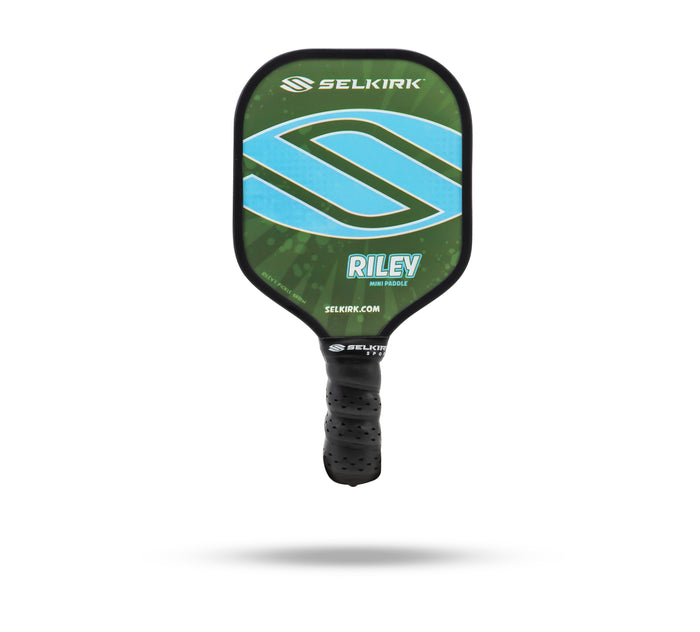 SELKIRK RILEY mini paddle — green face with blue logo and textured black handle; SELKIRK.COM visible.