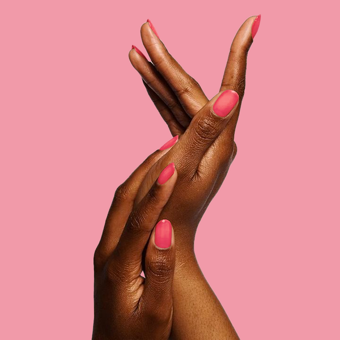 Hands with medium-length nails painted vibrant pink gel polish in Strawberries Are in Season Right Now manicure
