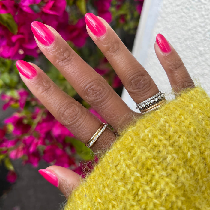 Hand with medium-length nails painted vibrant jelly pink gel polish in Strawberries Are in Season Right Now manicure