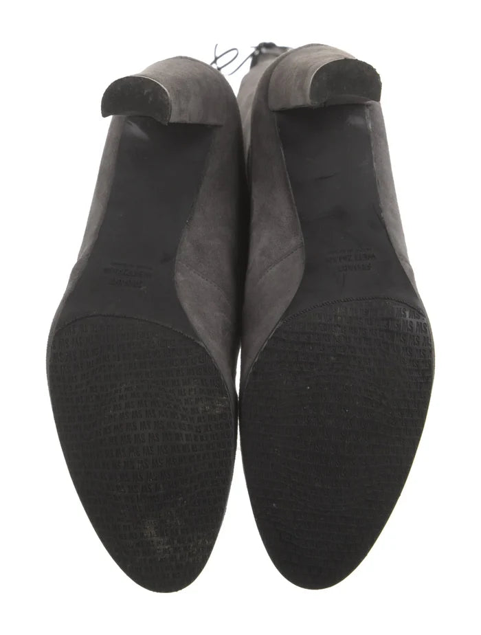 Stuart Weitzman suede boots in size 9 featuring a sleek ankle design and elegant high heel, displayed against a neutral background.