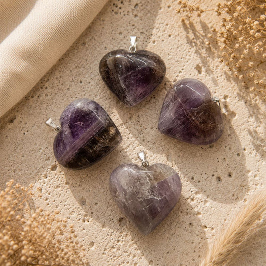 Super Seven Mini Heart Pendants on a neutral stone background