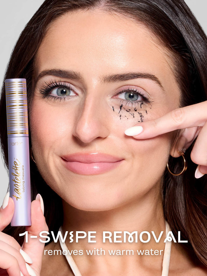 Two purple mascara tubes, one labeled 'travel-size' and the other 'full-size', on a light purple background.