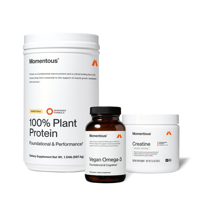 Three Momentous supplement containers: white vanilla-flavored plant protein powder, brown vegan omega-3 capsule bottle, and white creatine jar.