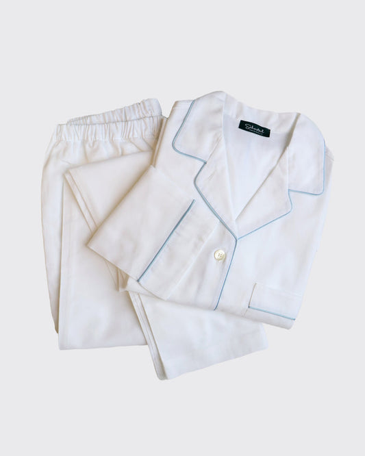 White pajama set with light blue piping on a white background